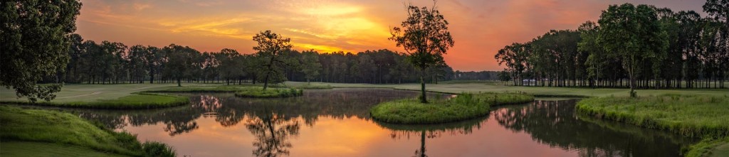 Panoramic golf course view overlooking the water at dawn - The Refuge Golf Course in Flowood, MS.